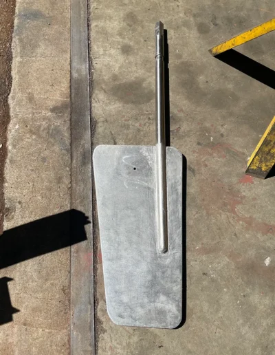 Fabricated aluminum rudder with stainless steel shaft ready for marine installation.