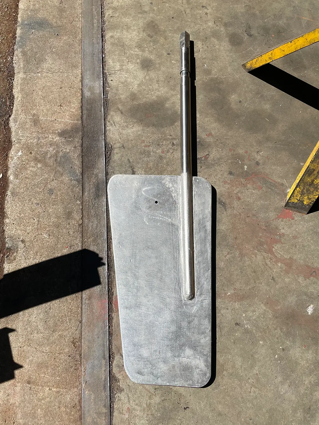 Fabricated aluminum rudder with stainless steel shaft ready for marine installation.