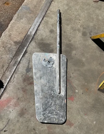 Worn aluminum rudder and shaft showing corrosion prior to welding repair.