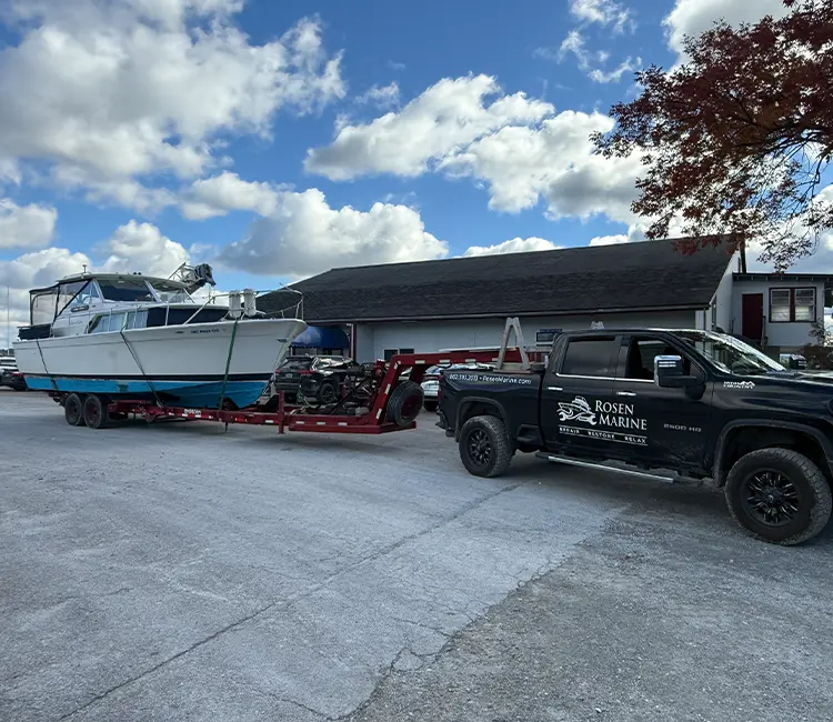 Rosen Marine truck hauling a cabin cruiser on a trailer