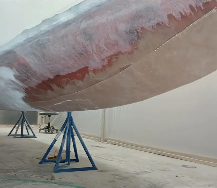 Boat hull repair in Vermont showing fiberglass repair area during prep and fairing