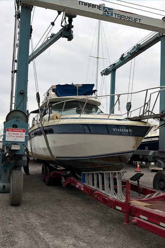 Sailboat positioned at a boatyard for loading and transport
