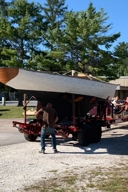 Sailboat being prepared for transport on a hydraulic trailer