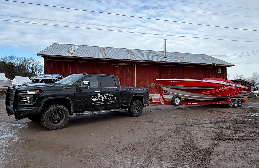 Rosen Marine truck towing a red boat on trailer in South Hero Vermont